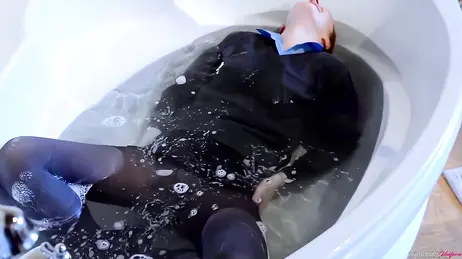 For water and stocking fetishists: she gets in the bathtub wearing her college uniform