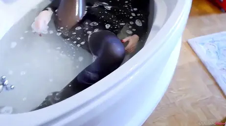 For water and stocking fetishists: she gets in the bathtub wearing her college uniform