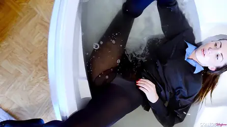 For water and stocking fetishists: she gets in the bathtub wearing her college uniform